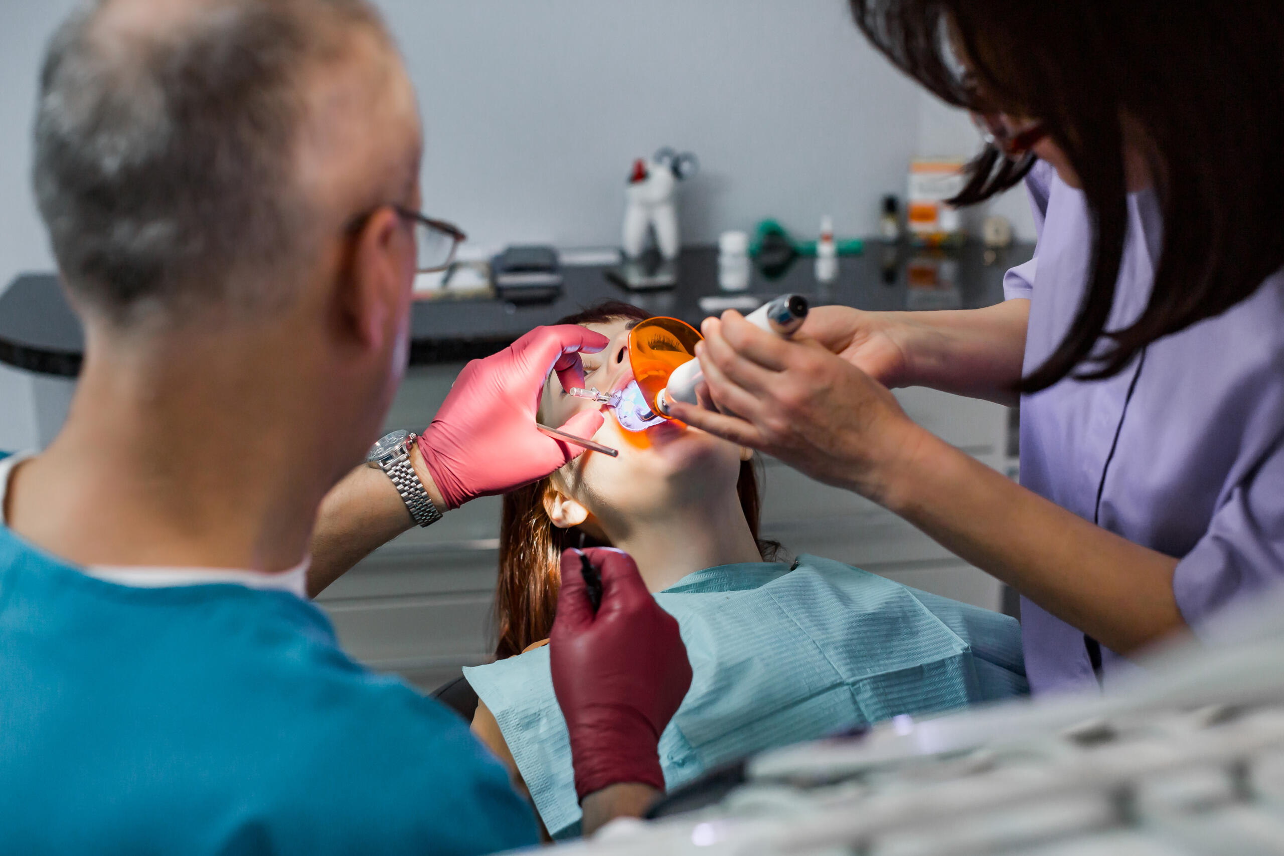 Young female patient takes a dental attendance in the dentist's office.